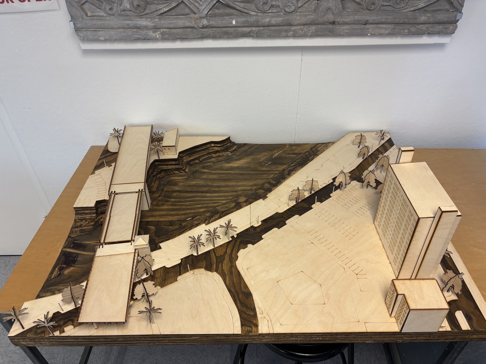 The river site model from above, the bridge crossing the dark stained river