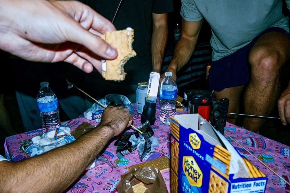 Hands over a table at night